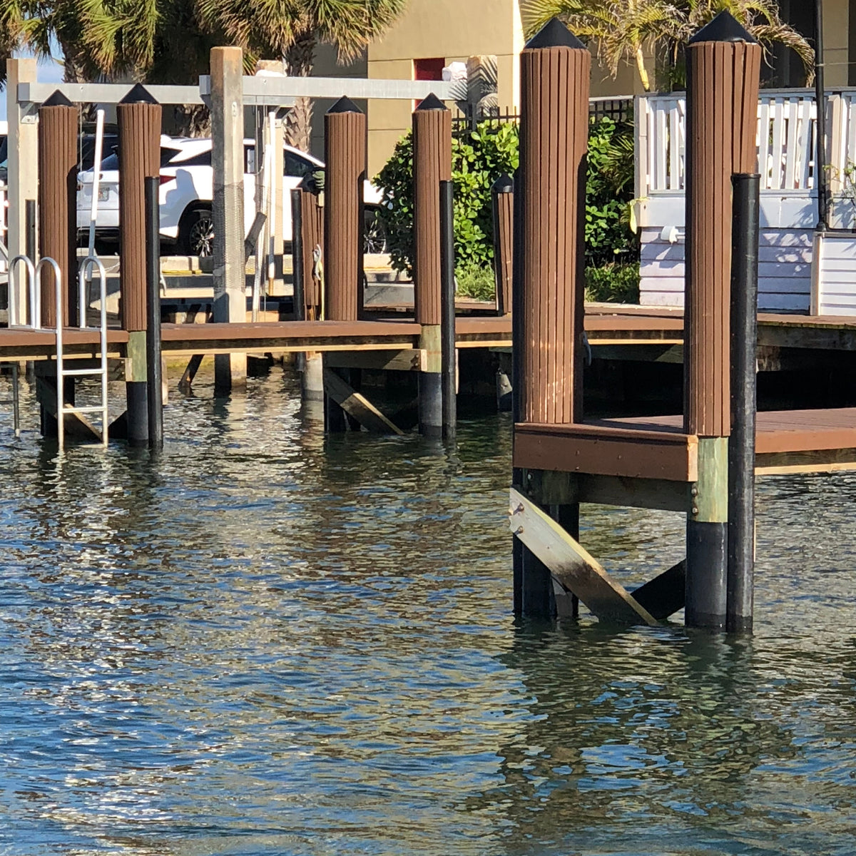 HDPE piling wrap installed on multiple dock pilings