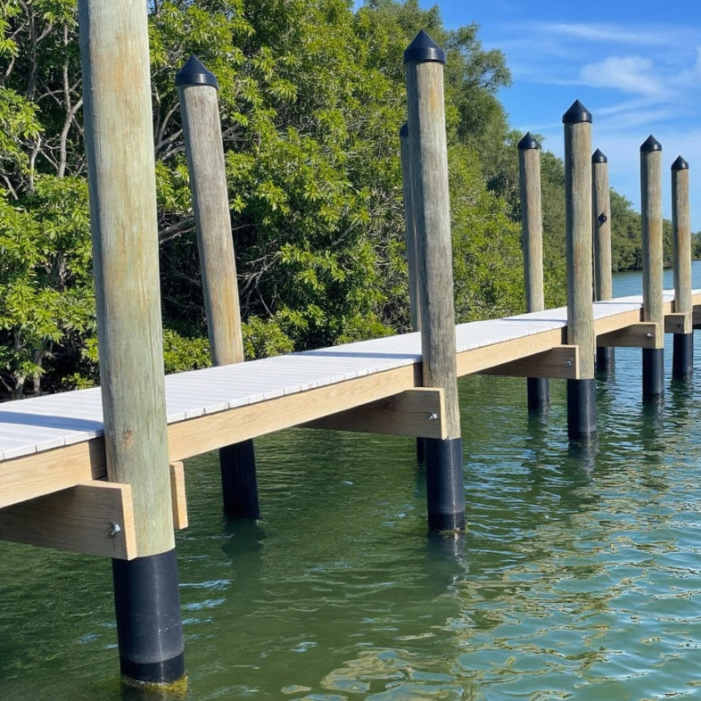 A dock with each piling wrapped in Pier Protector