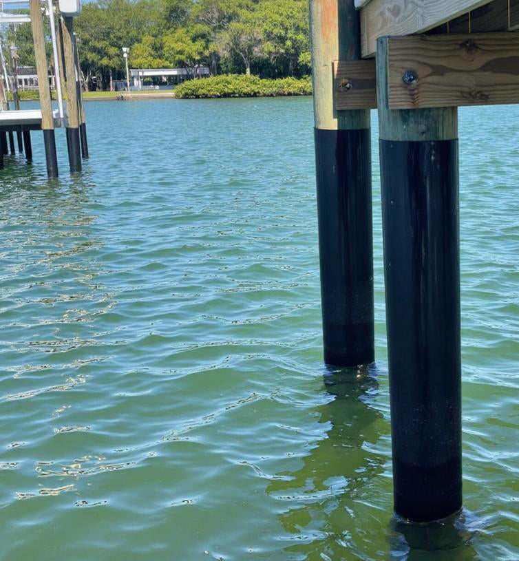 Close view of wrapped pilings standing in water
